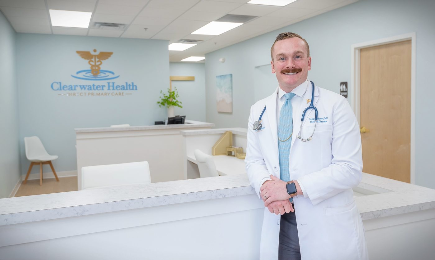 Dr. Tanner Moore, MD standing in the Clearwater Health Direct Primary Care clinic